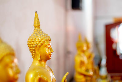 Close-up of buddha statue against building