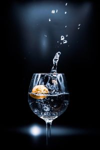 Close-up of wine glass against black background