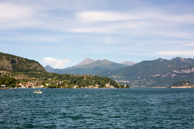 Scenic view of sea and mountains against sky