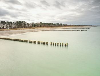 Scenic view of lake against sky during winter