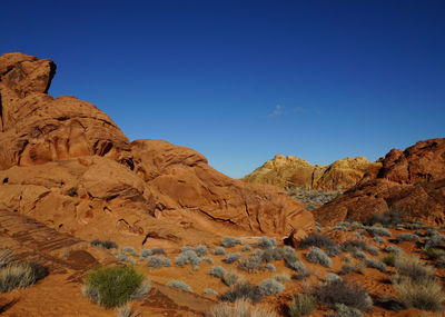 Scenic view of mountains against blue sky