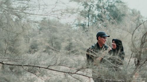 Couple kissing in forest during winter