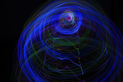 Light painting abstract colorful irregular lines or patterns on black background with long exposure.