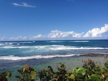 Scenic view of sea against blue sky