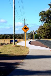 Road sign against sky