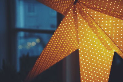 Close-up of illuminated lamp at night