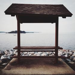 Seat on pier against sea