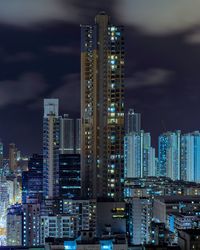 View of skyscrapers lit up at night