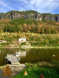 Scenic view of lake by trees and buildings