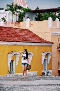 Woman standing in front of building