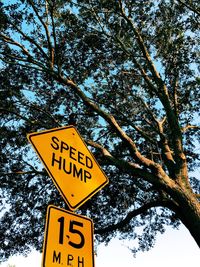 Low angle view of road sign against sky