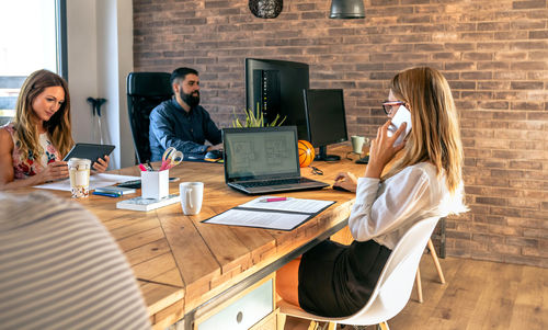 People working on table at home