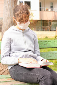 Midsection of woman reading book