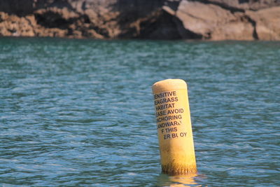 Close-up of text on lake