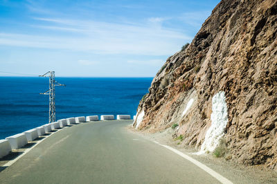 Road by sea against sky