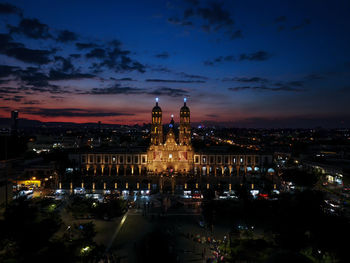 Illuminated buildings in city at night