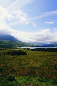 Scenic view of landscape against cloudy sky