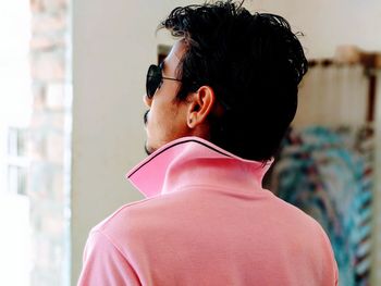 Rear view of man in pink t-shirt