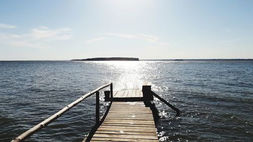 Pier over sea against sky