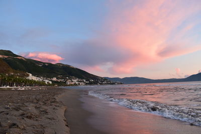 Scenic view of beach against sky during sunset