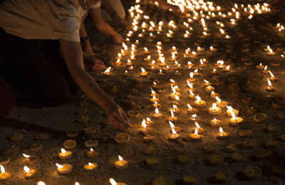 Low angle view of lit candles in temple