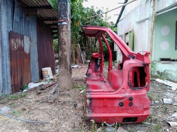 Abandoned truck on field against building