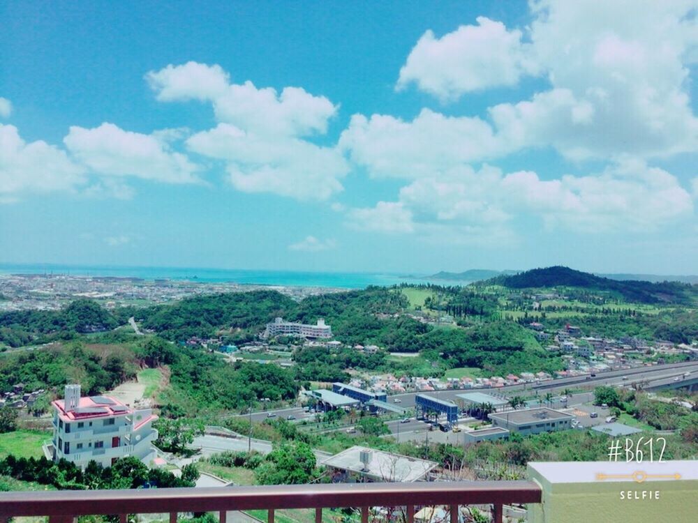 sky, built structure, architecture, building exterior, high angle view, mountain, cloud - sky, tree, water, cityscape, sea, cloud, landscape, scenics, city, river, nature, blue, town, beauty in nature