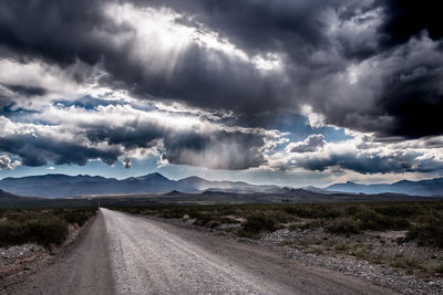 Road by landscape against sky