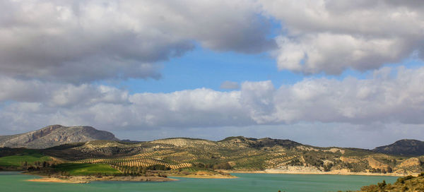 Panoramic view of sea and mountains against sky