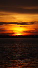 Scenic view of sea against romantic sky at sunset