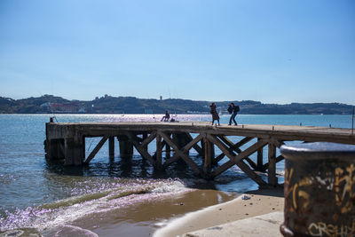 Man on beach against clear blue sky