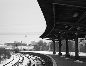 Empty railroad station with fernsehturm in background during winter