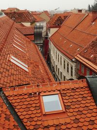 High angle view of residential buildings in town against sky