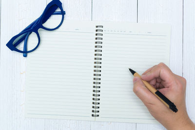 Cropped image of hand holding book