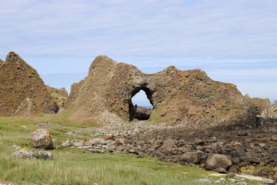 Rock formation on land against sky