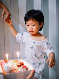 Portrait of cute girl blowing birthday cake