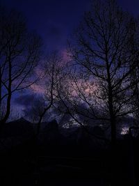 Low angle view of silhouette bare trees against sky at night