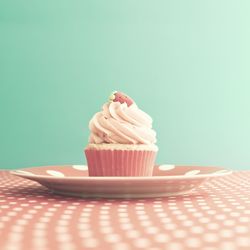 Close-up of cupcake on table against blue background