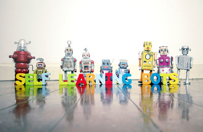 Close-up of toys on table against white background