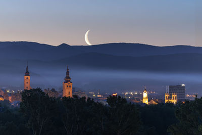 Low angle view of city at moonrise