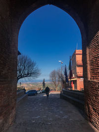 Rear view of man walking on road