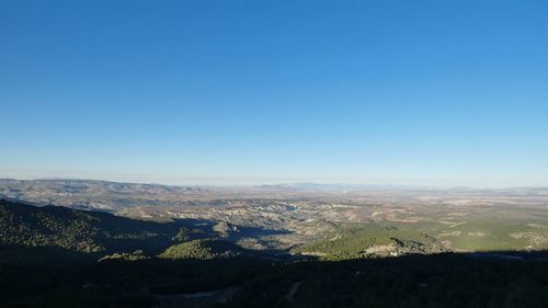 Scenic view of dramatic landscape against clear blue sky