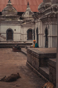 Rear view of woman walking in temple