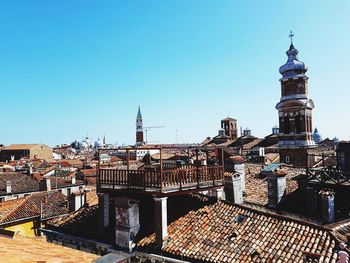 View of cityscape against clear blue sky