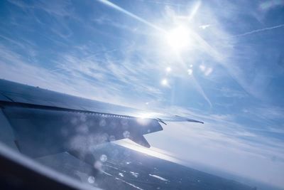 Close-up of airplane wing against sky