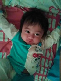 Portrait of cute baby girl on bed