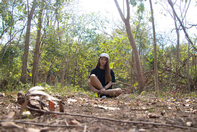 Woman sitting in forest