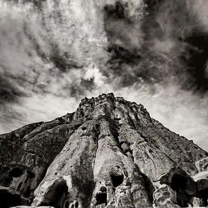 Low angle view of mountain against cloudy sky