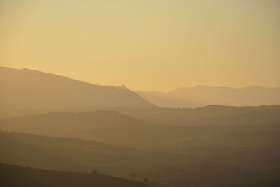 Scenic view of silhouette mountains against sky during sunset