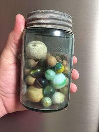 Close-up of hand holding ice cream in jar